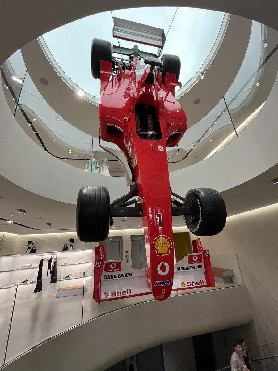 Red Ferrari Formula 1 car suspended inside the Ferrari store